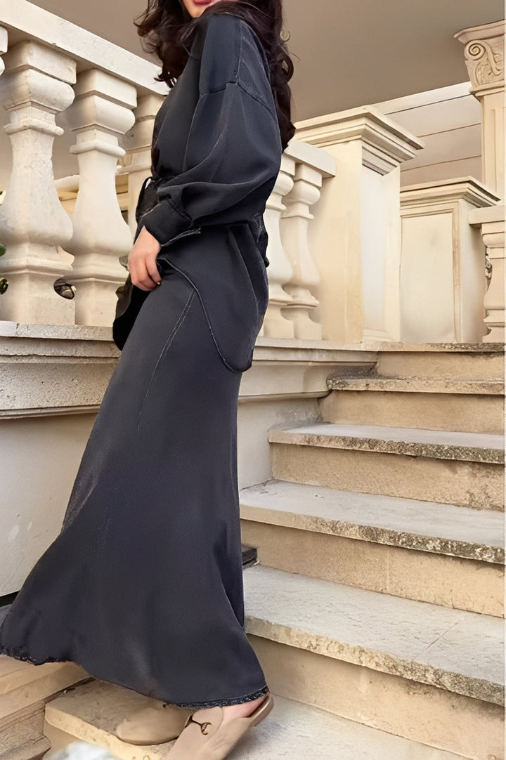 Fashionable women's two-piece set with a stylish button-up shirt and a flowing maxi skirt. Modern dress style.