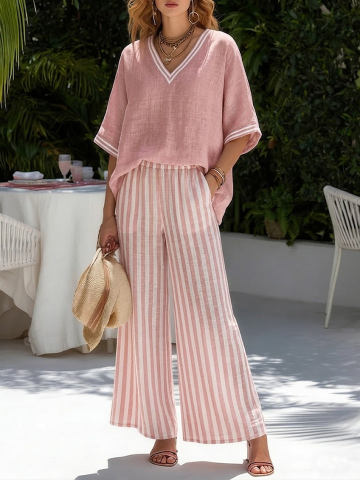 Comfortable women's V-neck top & stripe pants lounge wear set. Stylish two-piece outfit for relaxed fashion.