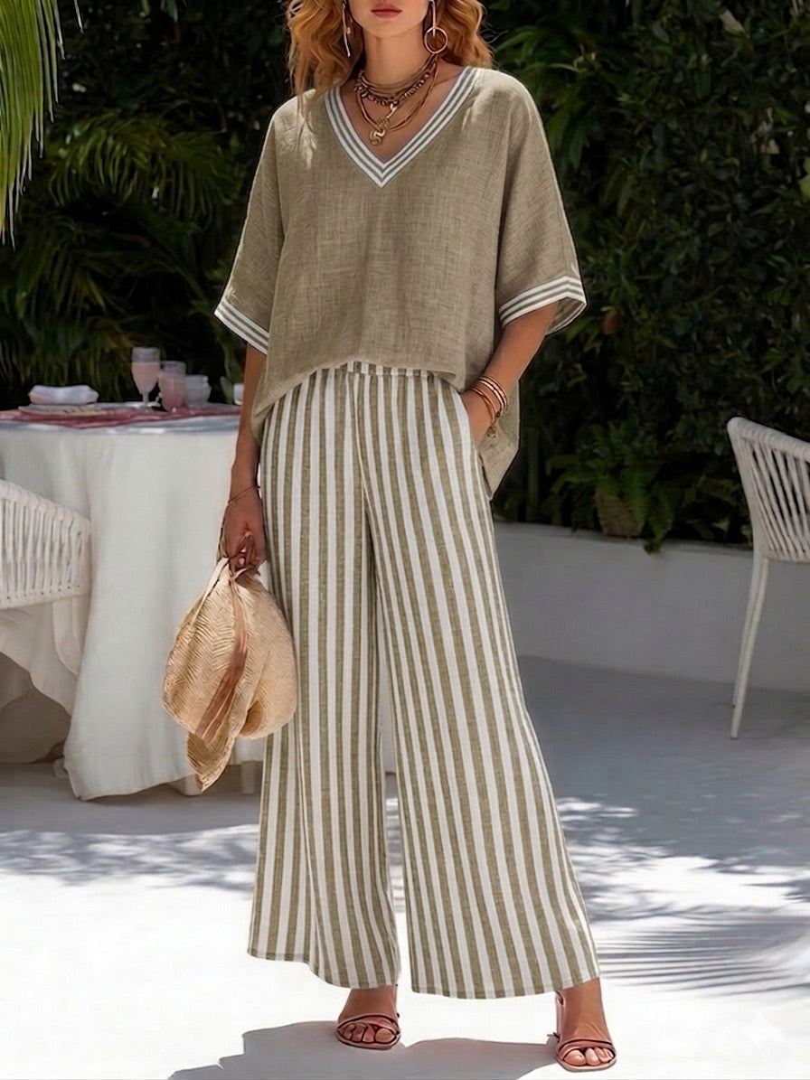 Stylish women's V-neck top & stripe pants two-piece set. Elegant, comfortable matching outfit for casual and fashion wear.