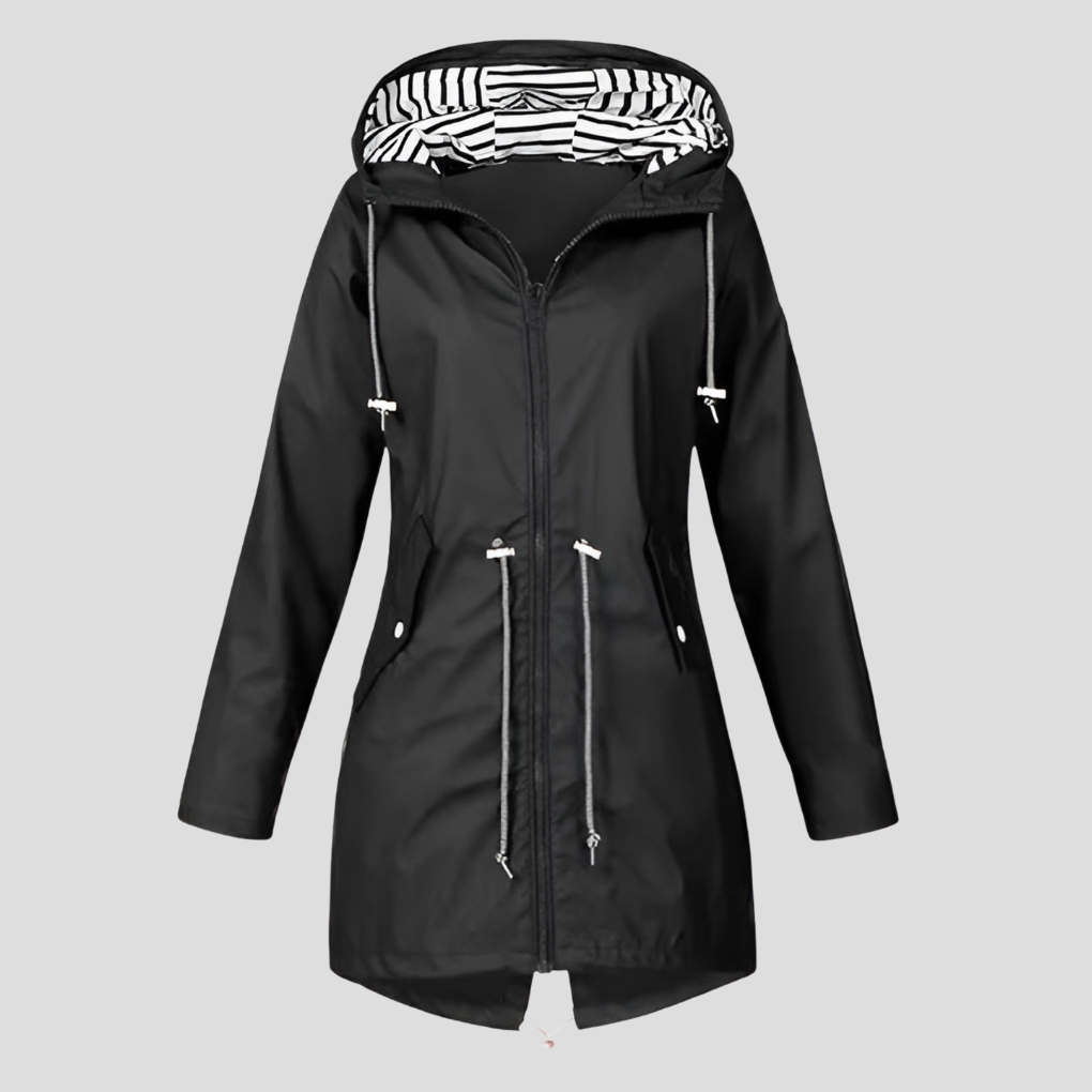 Woman wearing a versatile lightweight hooded rain jacket, ideal for travel & active lifestyles in spring/fall.