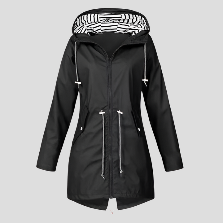 Woman wearing a versatile lightweight hooded rain jacket, ideal for travel & active lifestyles in spring/fall.