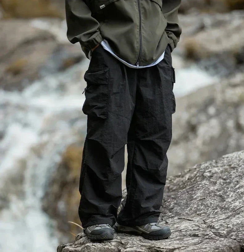 Woman hiking in stylish waterproof outdoor pants, perfect for trails and rugged terrain.