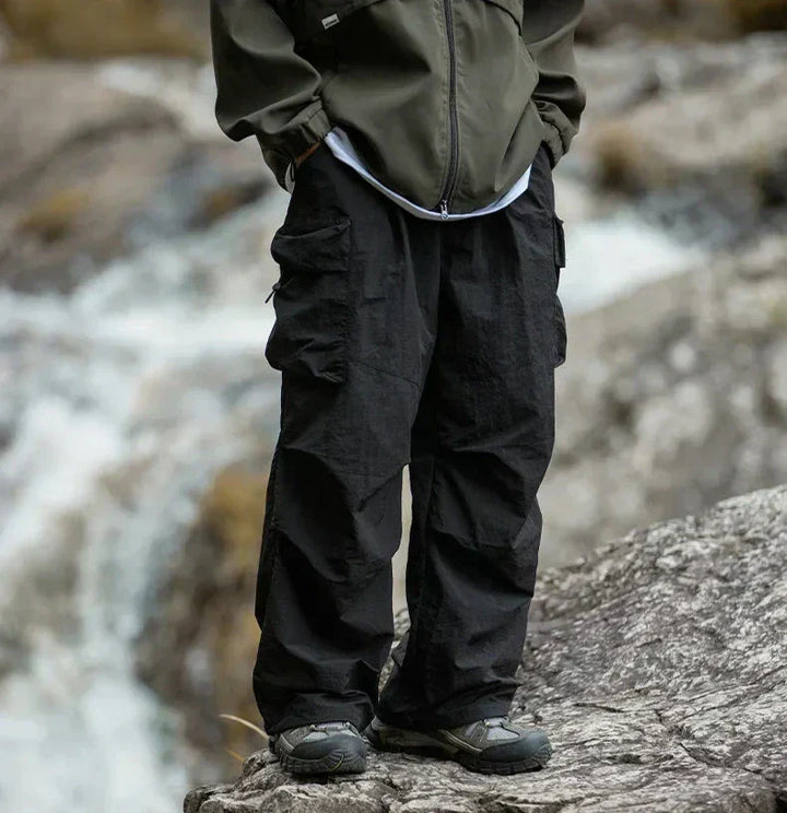 Woman hiking in stylish waterproof outdoor pants, perfect for trails and rugged terrain.
