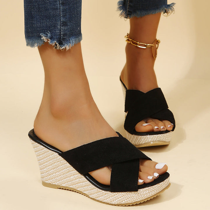 Easy slip-on women's wedge sandals with fashionable cross straps, essential for summer comfort & style.