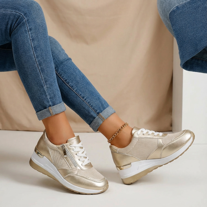Women's stylish wedge trainers with side zip, offering a comfortable lift for everyday wear.