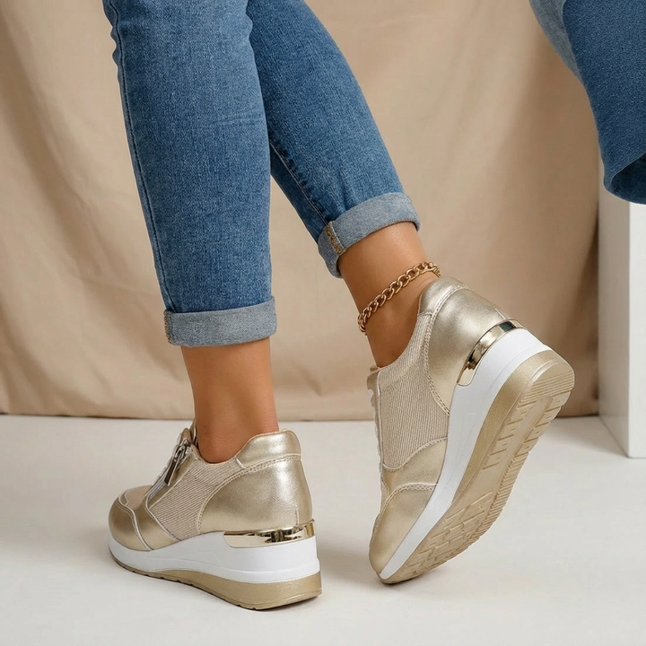 Chic metallic wedge trainers for women with a comfortable platform sole and practical side zip closure.