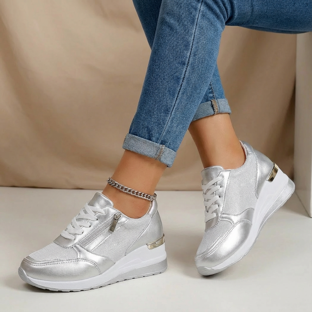 Silver women's chic wedge sneakers, designed for comfort and fashion, with a supportive lift and side zip.