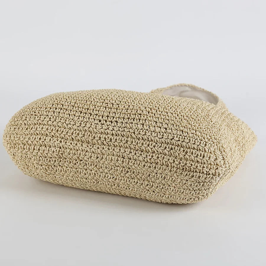 Fashionable women's straw shoulder bag, a chic summer hobo bag for beach outings or casual events.