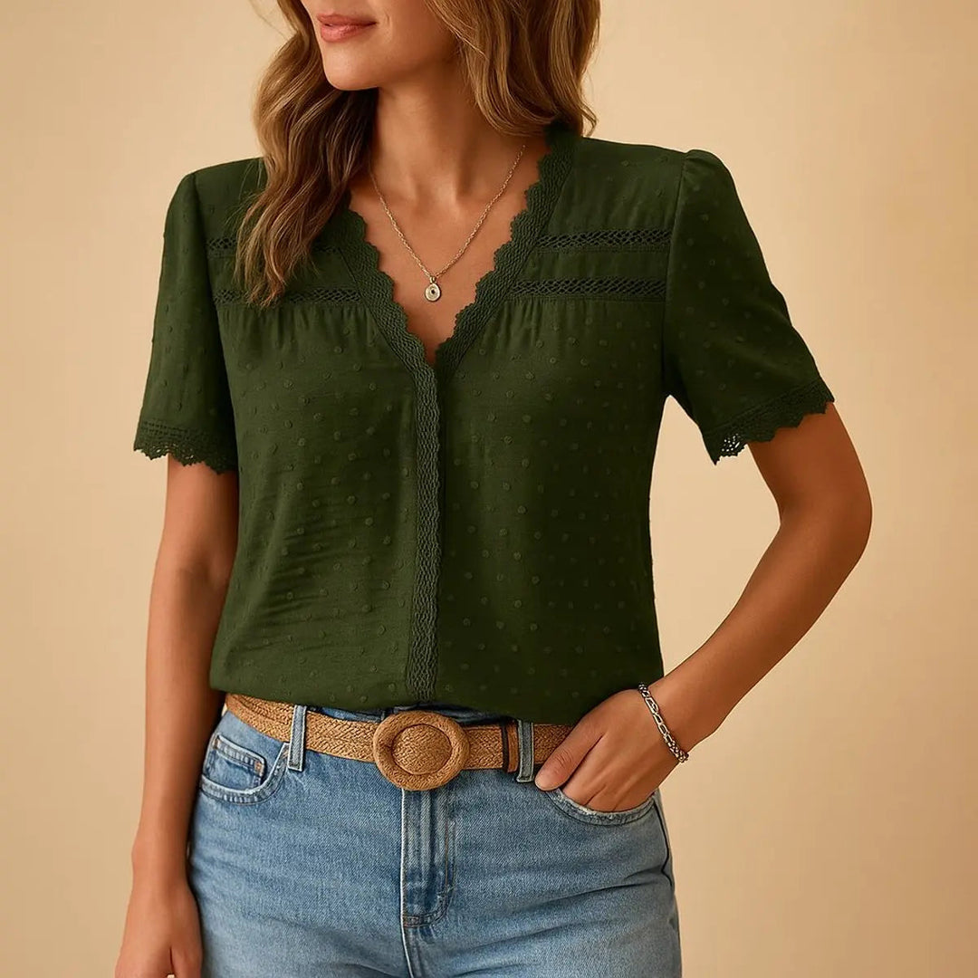 Relaxed fit women's Swiss Dot V-neck top with intricate lace trim. Perfect for smart casual or daily wear.