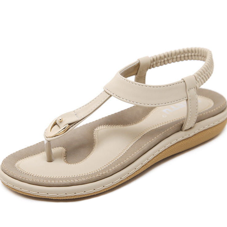 Stylish women's T-strap flat sandals featuring an elastic back & cushioned footbed for ultimate comfort.