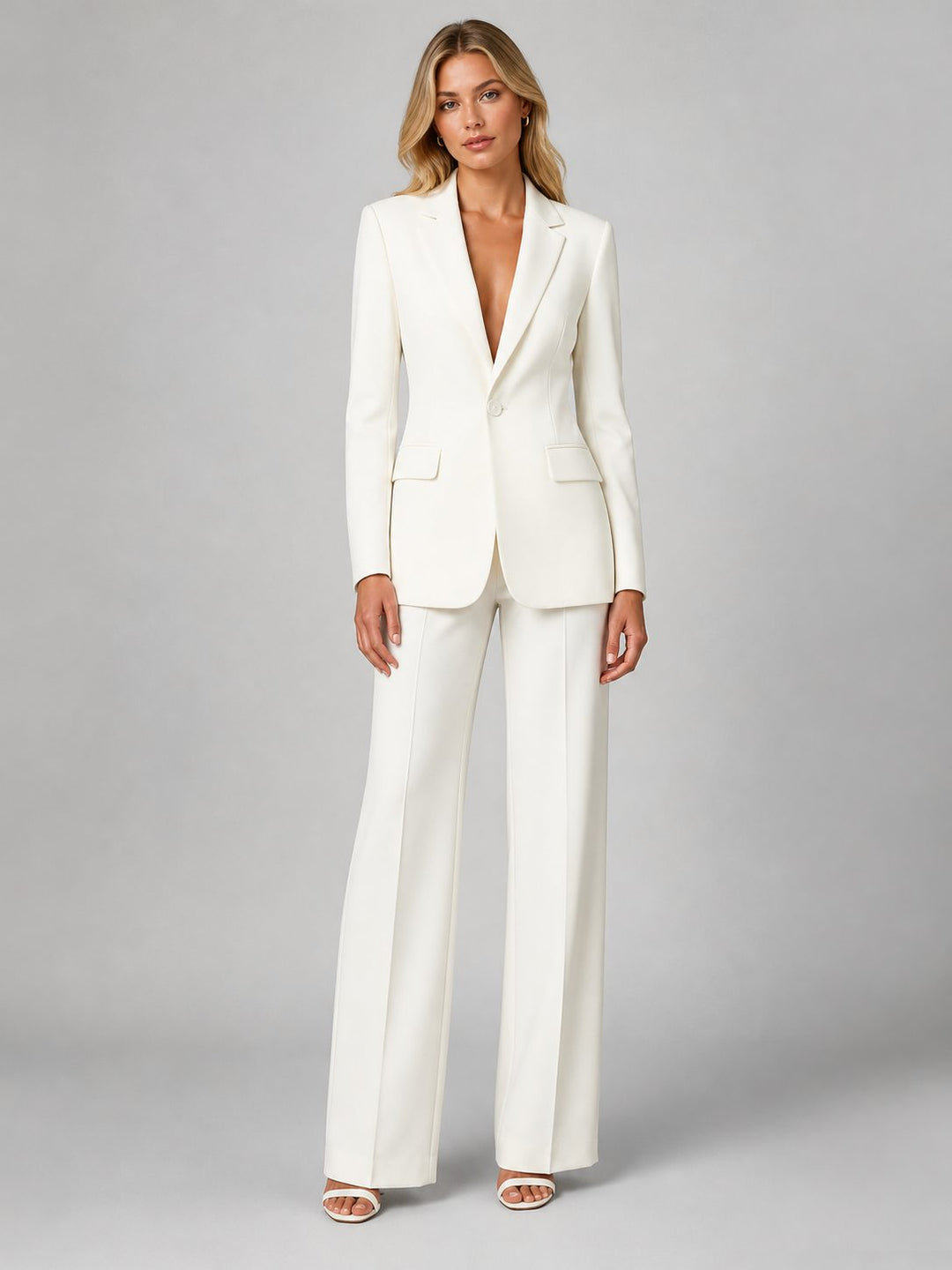 Women's tailored blazer and wide leg trousers set for professional office wear. Elegant business attire.