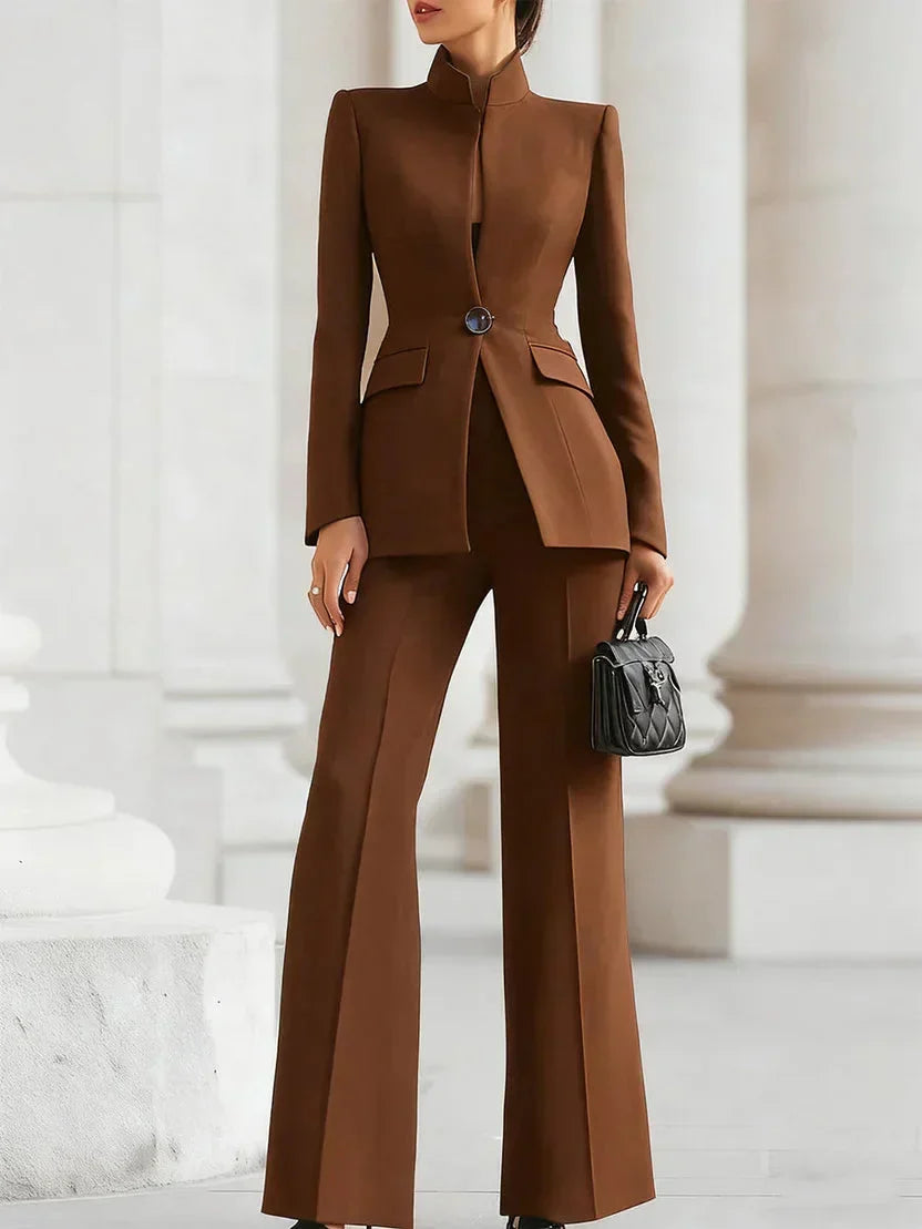 Close-up: Detail of women's tailored denim jacket & flare trousers set. Quality jeanswear fabric texture.