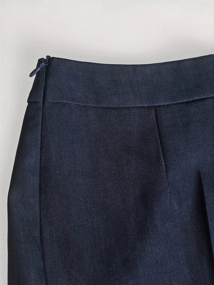 Back view: Women's tailored denim jacket and flare trousers set. Modern fashion longline top ensemble.