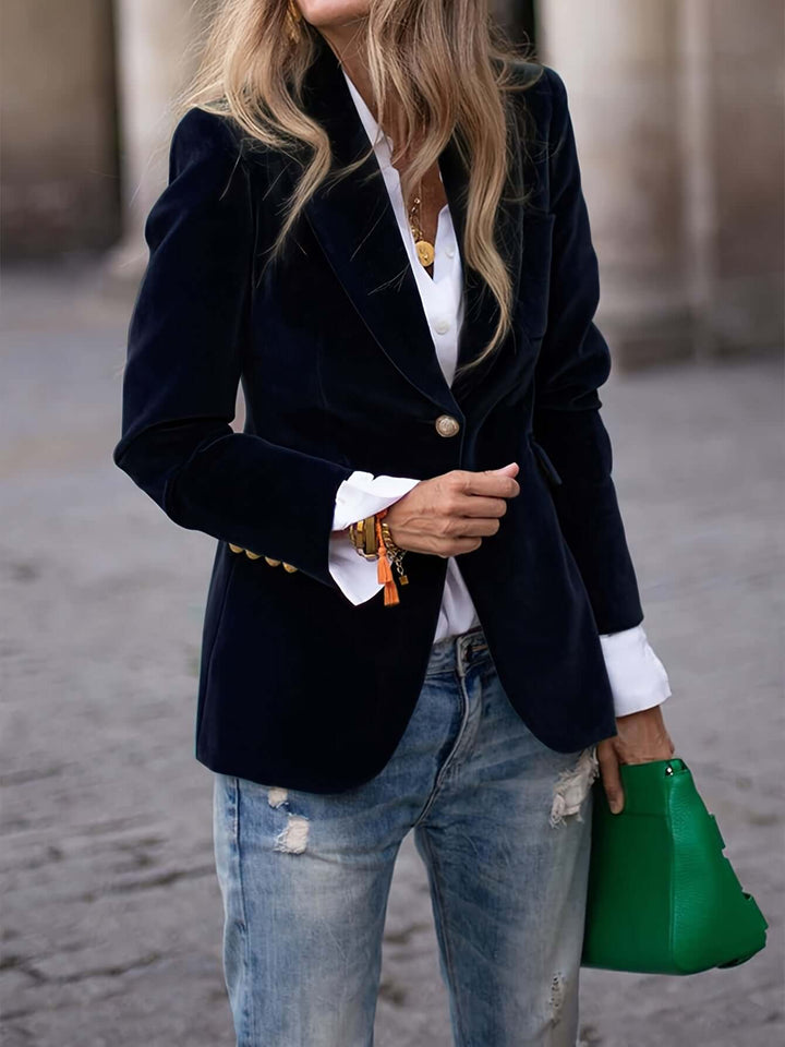 Elegant women's green blazer jacket with eye-catching golden buttons. Classic womens fashion piece.