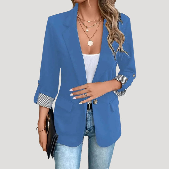 Elegantly tailored women's single-breasted blazer. Features roll-up sleeves for a versatile, modern fit. Office wear.