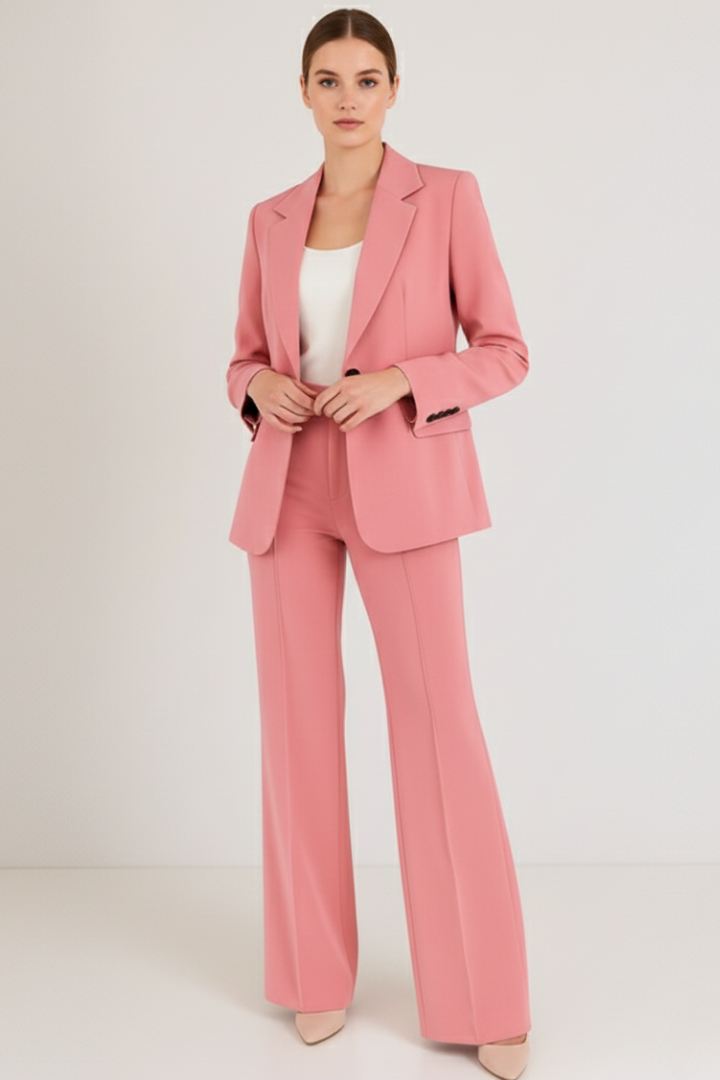 Impeccably tailored women's two-piece pantsuit, featuring a structured blazer and refined trousers for office.