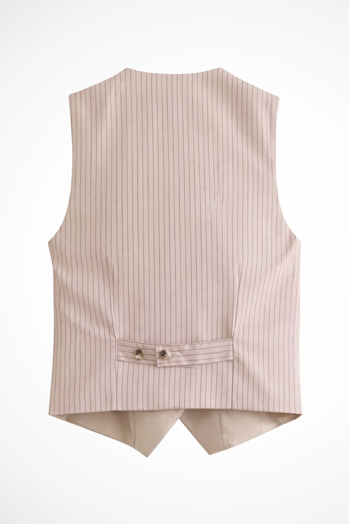 Close-up of a women's tailored suit fabric, showing the elegant texture of the waistcoat and trousers set.