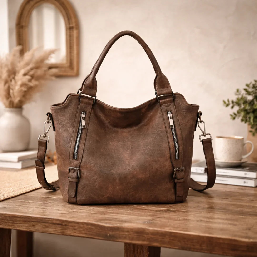 Elegant tan faux-leather slouchy women's shoulder bag, versatile for any outfit, with zipper pockets.