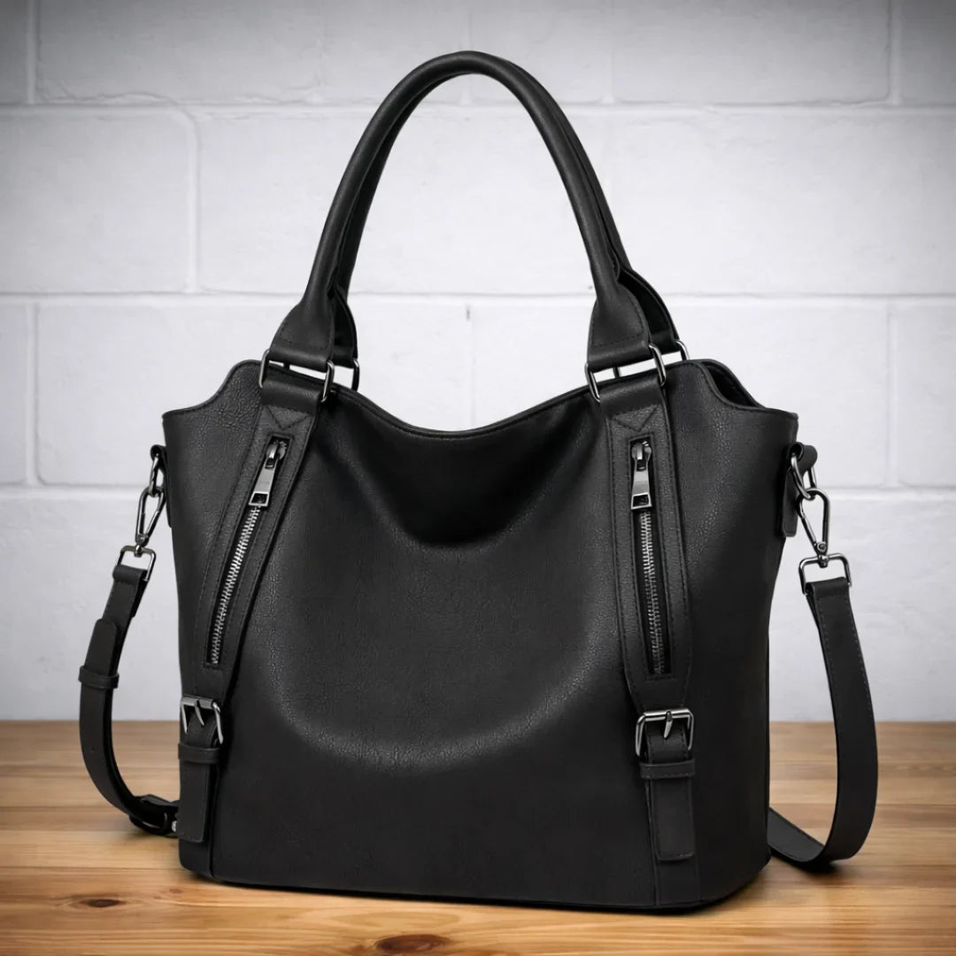 Woman wearing a chic tan faux-leather slouchy crossbody bag, an ideal fashion accessory.