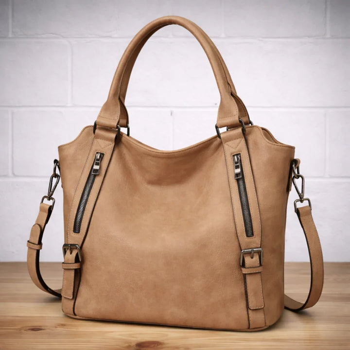 Rear view of women's tan slouchy shoulder bag, showcasing the adjustable faux-leather strap.