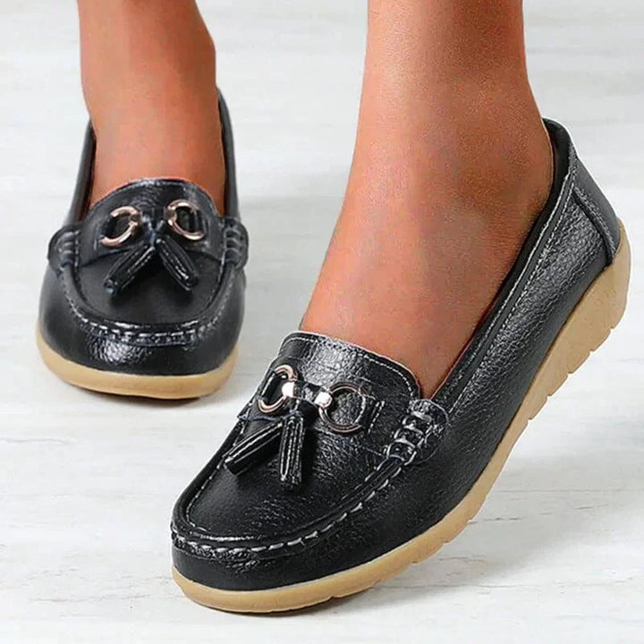 Casual women's tassel loafers with prominent gold buckle, classic moc toe. Perfect slip-on flat shoes.