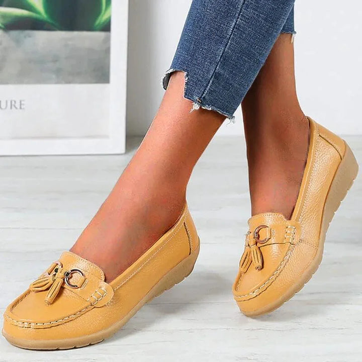 Comfortable women's slip-on tassel loafers. Features a gold buckle, moc toe, ideal for everyday wear.