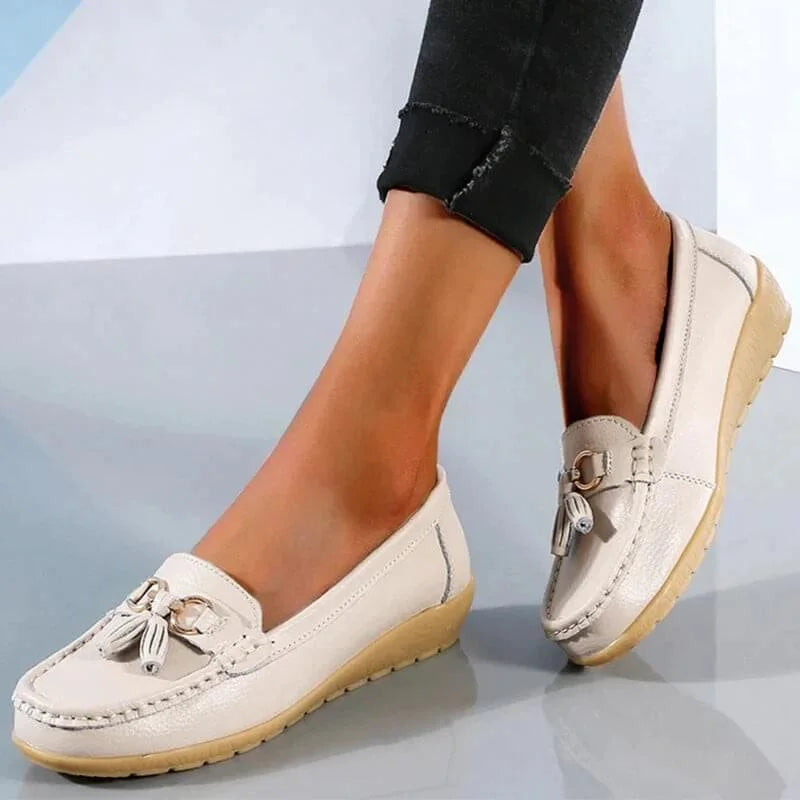 Modern women's tassel loafers. Sophisticated gold buckle, moc toe design for smart casual comfort.