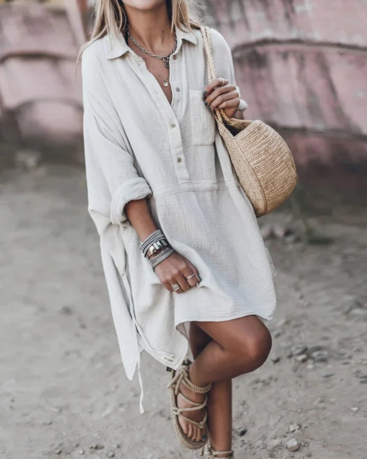 Women's textured collared flowy mini dress with roll-tab sleeves, ideal for chic casual daywear.