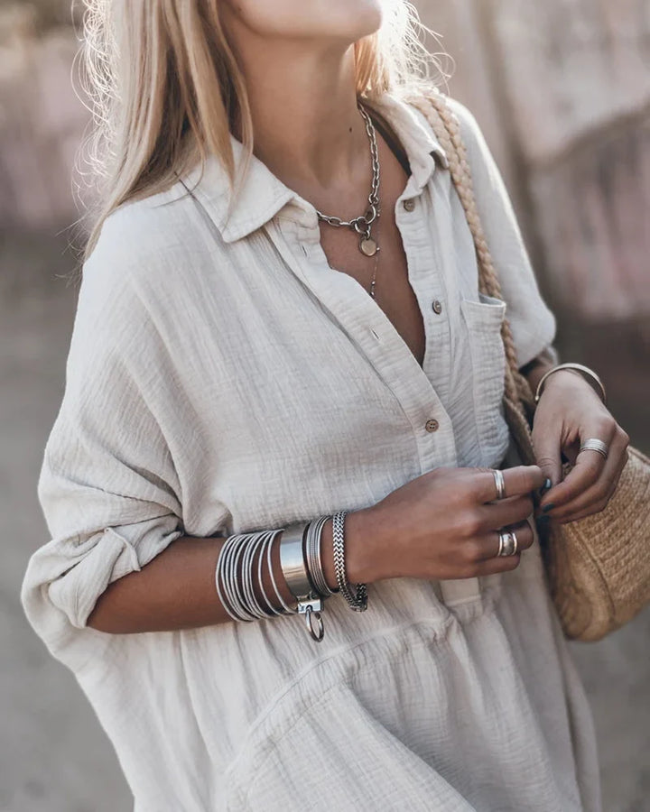 Stylish women's collared textured mini dress with a comfortable flowy silhouette and practical roll-tab sleeves.
