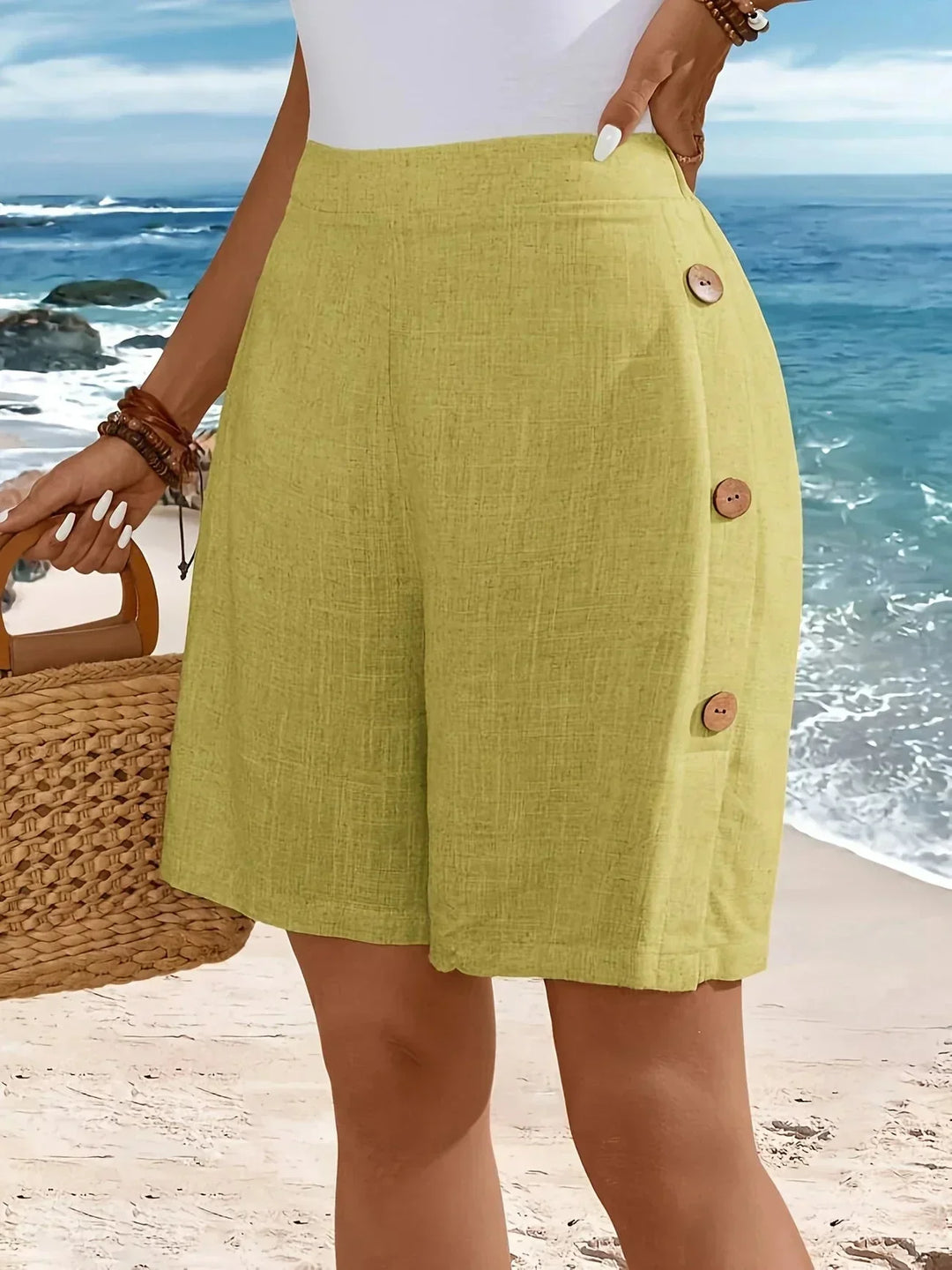 Women's textured high-waisted wide-leg shorts with stylish side buttons. Perfect comfy summer casual wear.