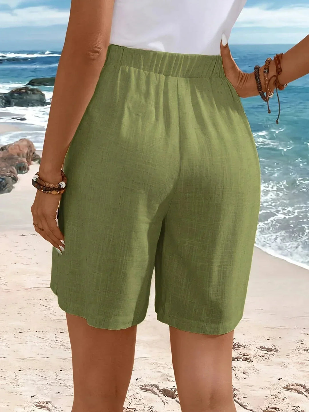 Fashionable women's high-waisted wide-leg shorts. Textured material offers a flattering, comfy fit with side buttons.