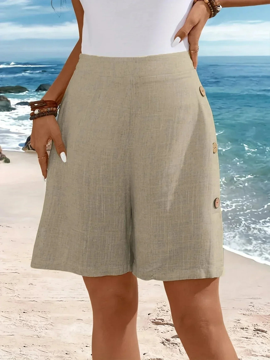 Vacation-perfect women's wide-leg shorts. High-waisted, textured, and styled with chic side buttons. Breezy summer.