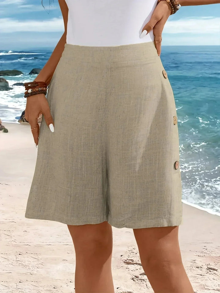 Vacation-perfect women's wide-leg shorts. High-waisted, textured, and styled with chic side buttons. Breezy summer.