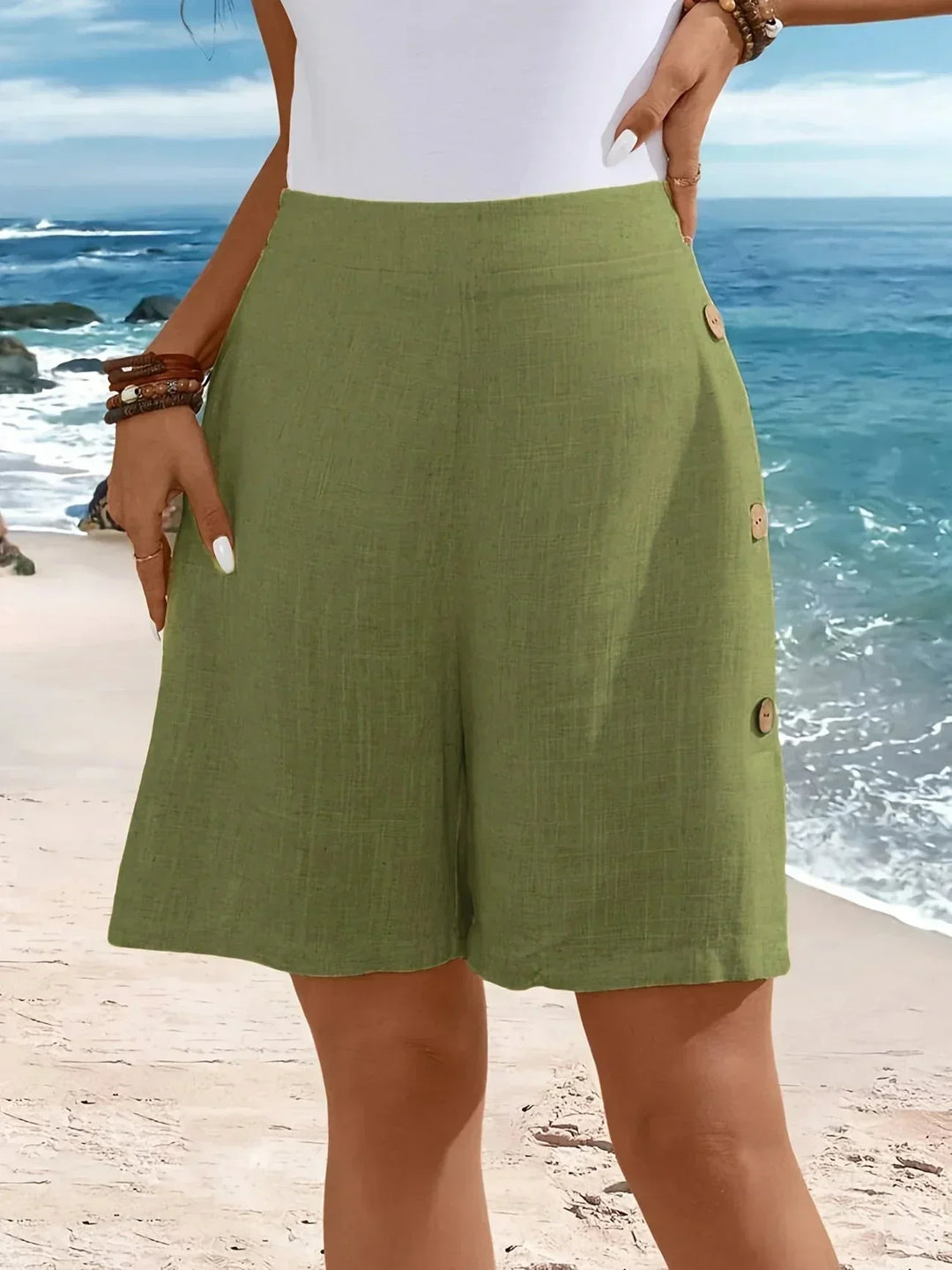 Summer-ready women's high-waisted wide-leg shorts. Textured, breezy, and features stylish side buttons for fashion.