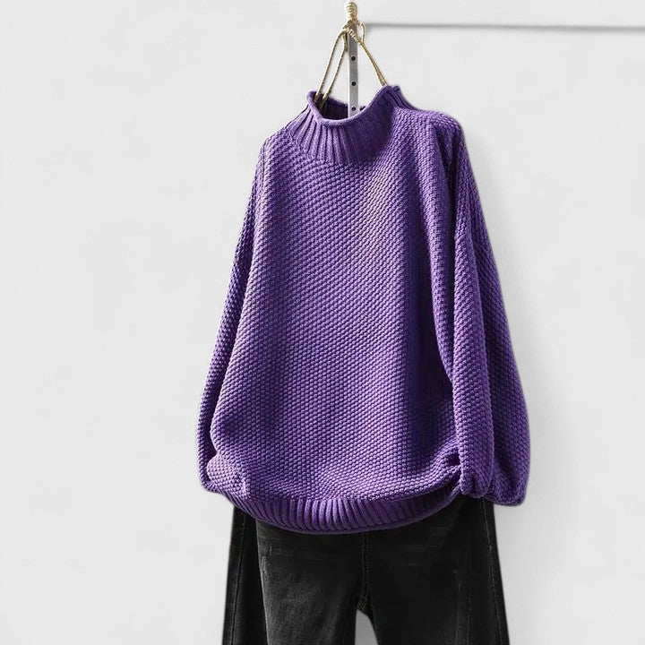 Close-up of the rich textured knit on a women's cozy mock neck sweater.
