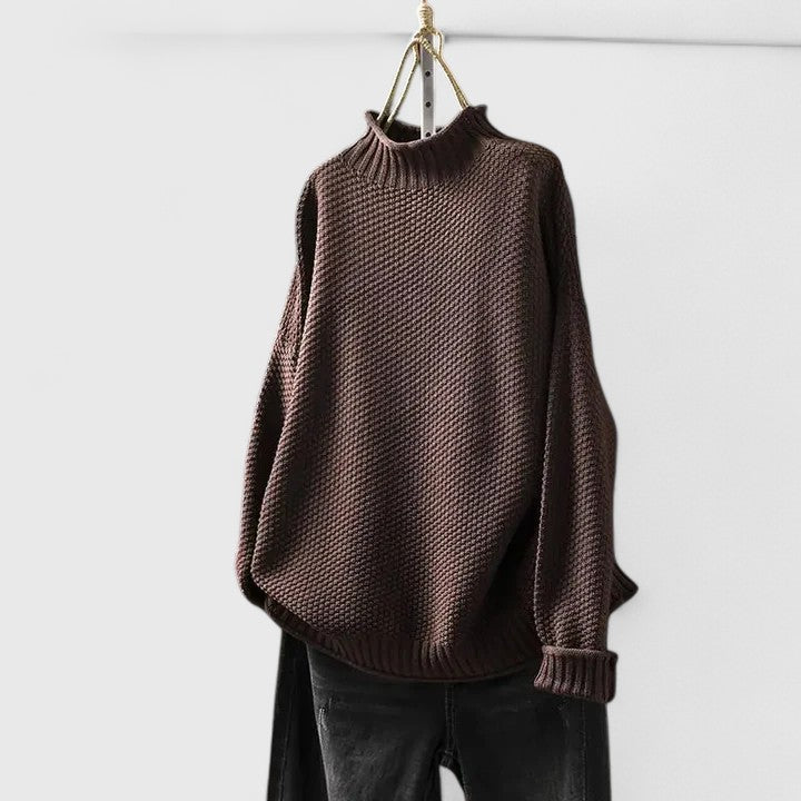 Side profile of a women's long sleeve mock neck jumper featuring stylish textured knit.