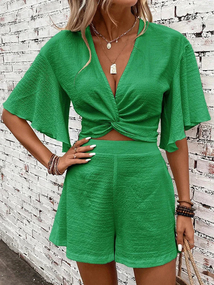 Textured V-neck crop top with flutter sleeves and matching high-waist shorts set for women. Summer casual wear.