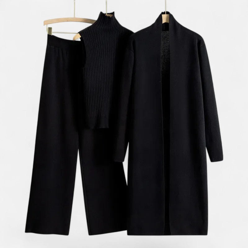 Versatile winter clothing: women's layered knit vest, cardigan, and trousers.