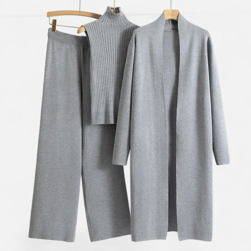 Women's knitwear set featuring a ribbed cardigan, vest, and wide-leg trousers.
