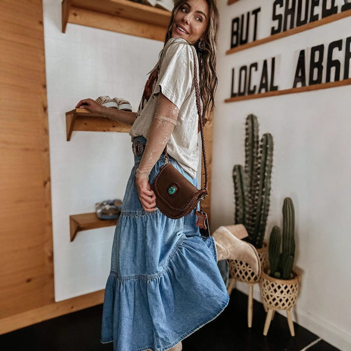 Casual women's tiered maxi skirt with a button front closure and distinctive raw hem detail.