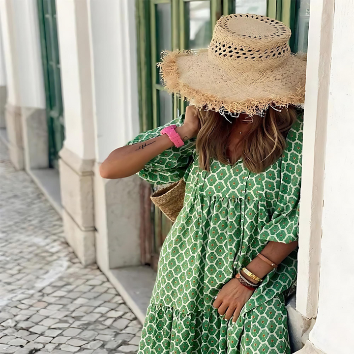 Women's summer tiered maxi dress with elegant floral print and balloon sleeves, suitable for warm weather.