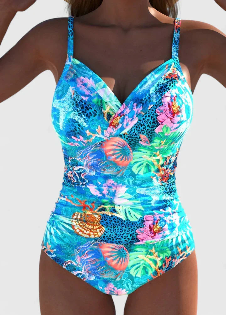 Stylish women's one-piece swimsuit with vibrant tropical print. Ideal for beach, resort wear, or summer pool days.