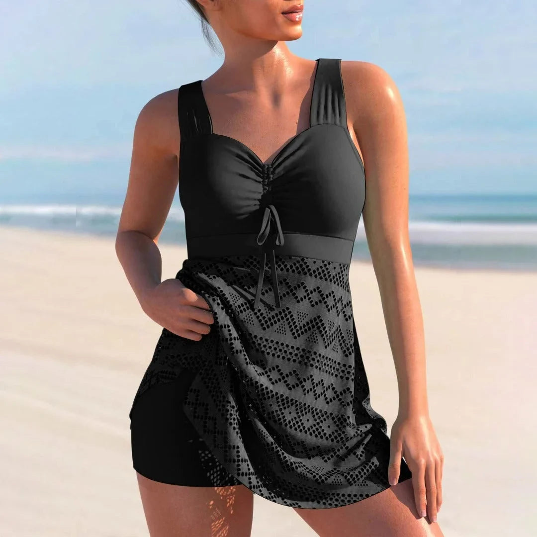 Women's tummy control tankini with ruched bust & skirt overlay for a flattering beach look.