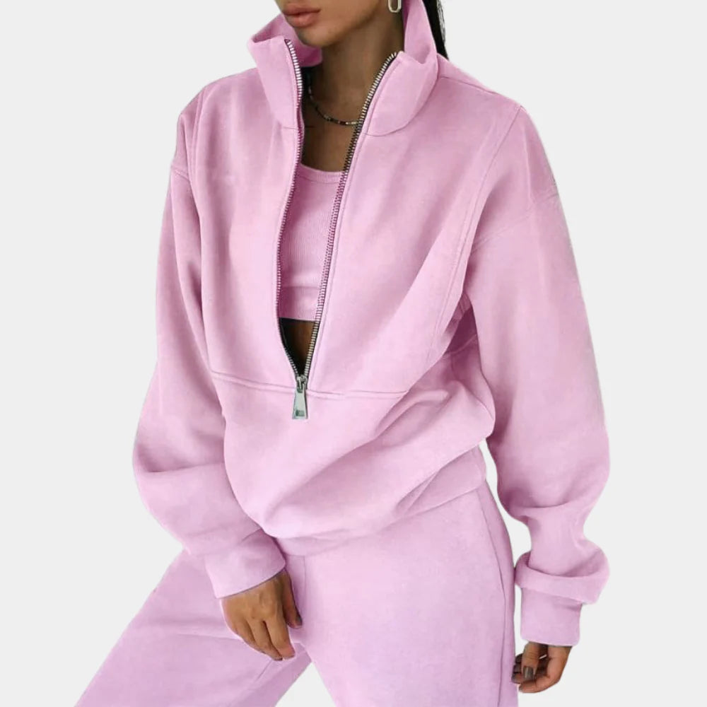Women's two-piece tracksuit set, comfortable pullover top & joggers for casual wear and lounge.
