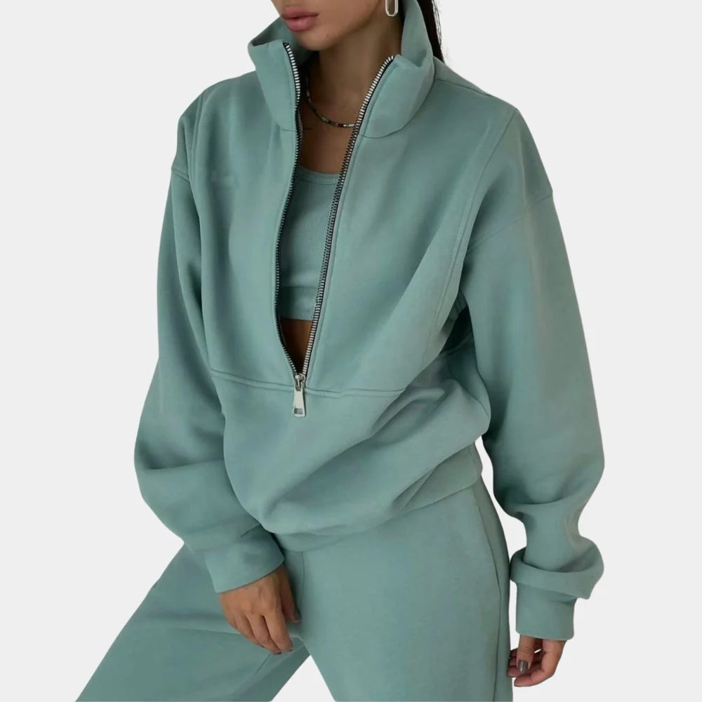 Women's stylish two-piece tracksuit with a comfortable pullover and jogger pants for relaxing.