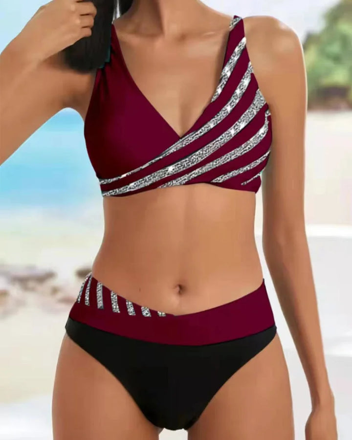 Vibrant two-tone striped women's high-waisted bikini set, ideal V-neck swimwear for your next vacation.
