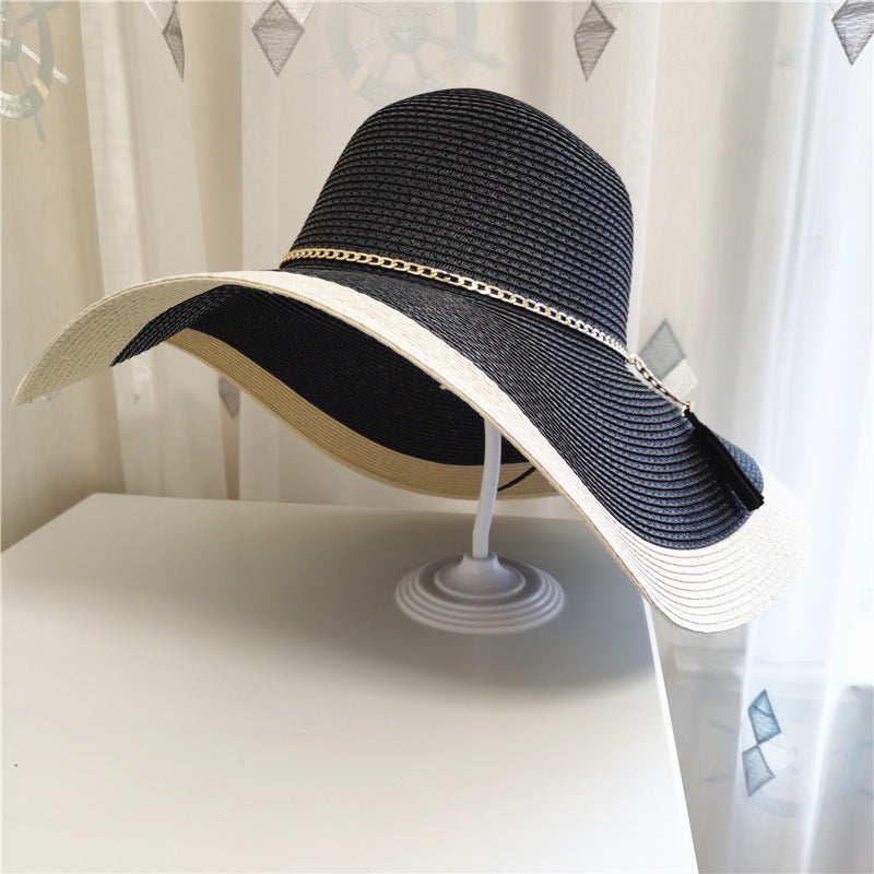 Chic women's wide brim straw sun hat with two-tone design. Perfect beach or resort wear, packable.