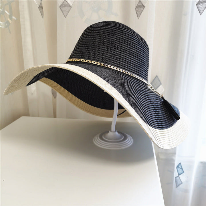 Chic women's wide brim straw sun hat with two-tone design. Perfect beach or resort wear, packable.