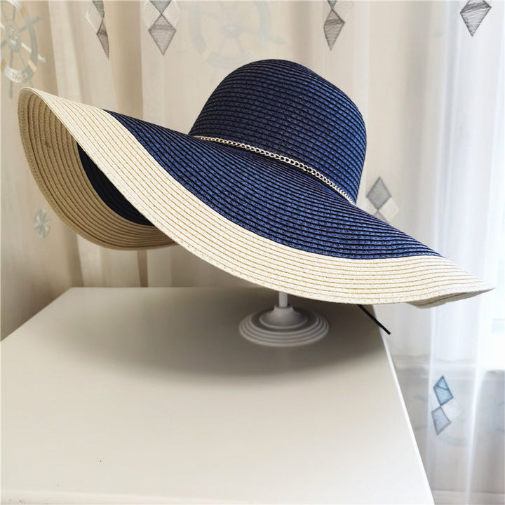 Elegant two-tone straw sun hat for women, wide brim provides ultimate sun protection for summer outings.