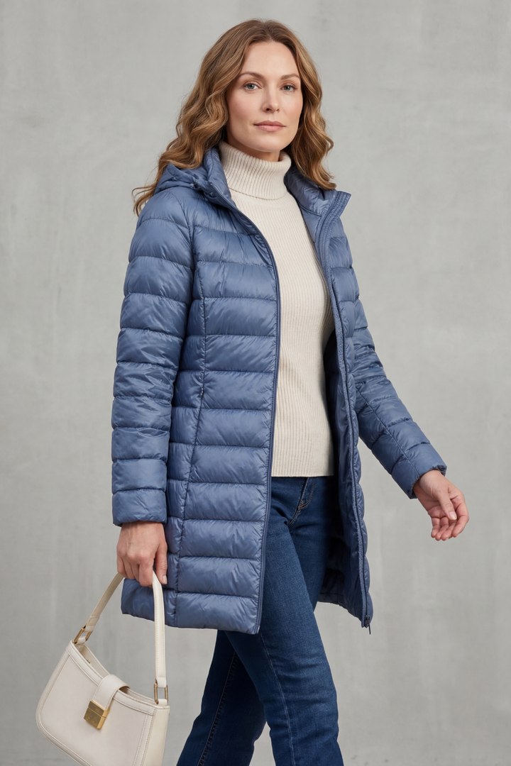 Lightweight women's packable puffer jacket. Hooded and cozy, ideal for fall/winter travel & warmth.